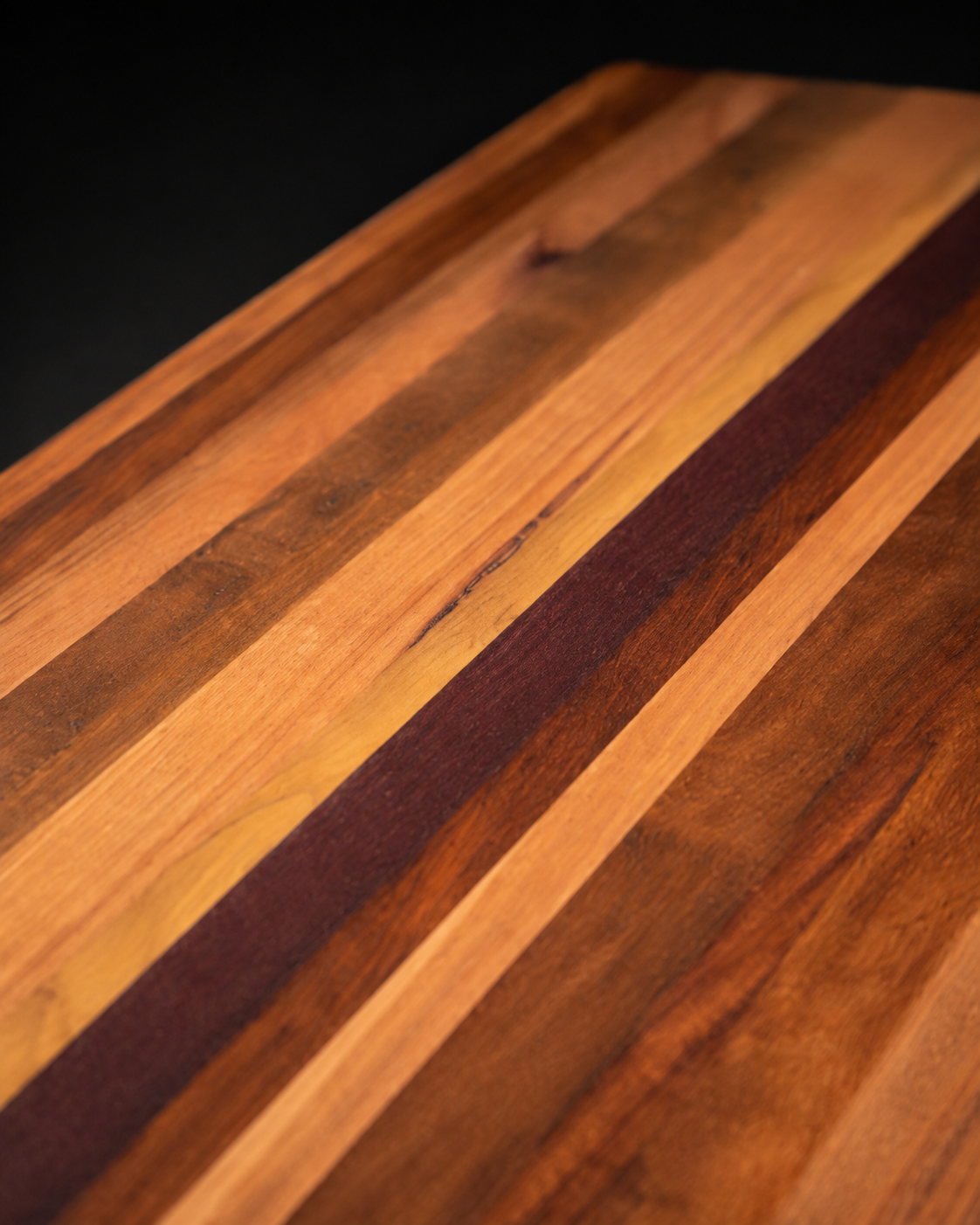 The Origin representative mixed Australian hardwood board, grain and timber stripe macro detail