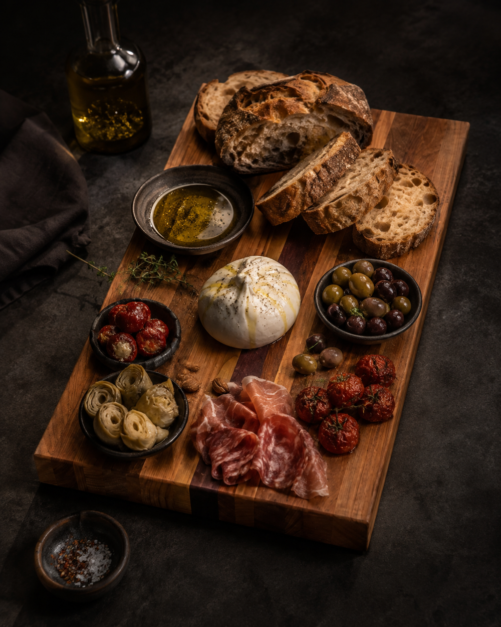The Origin representative mixed Australian hardwood board styled with artisan bread, burrata, antipasti and dipping oil